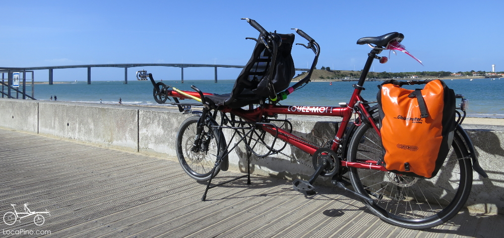 A Pino tandem bike by Hase Bikes on the beach with the bridge to the island of Noirmoutier